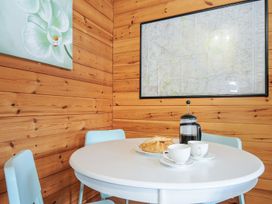A dining room with a round table and chairs at Trevano in St Breward