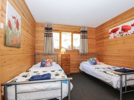 A bedroom with two beds and a dresser at Trevano in St Breward