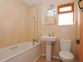 A bathroom with a bath tub sink and toilet at Trevano St Breward