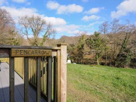 A view of a wooden railing with a sign at Pencarrow in St Breward