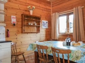 A kitchen with a table and chairs at Pencarrow in St Breward