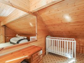 An attic with a crib and a sofa at Pencarrow in St Breward