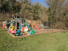 An outdoor play area with slides and toy cars at Pencarrow in St Breward
