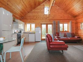 A living room with kitchen appliances and furniture at Trebah in St Breward