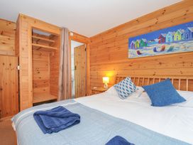 A bedroom with a bed and dresser at Trebah in St Breward