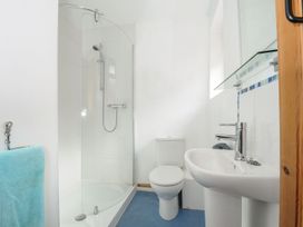 A bathroom featuring a shower, toilet, and sink at Trebah in St Breward