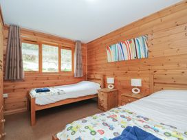 A bedroom with two beds and nightstands at Trebah in St Breward