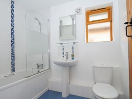 A bathroom with a bathtub, shower, sink, and toilet at Trebah in St Breward