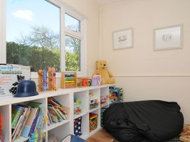 A playroom with books and toys on shelves at Trebah in St Breward