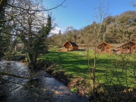 Three cabins by a stream in an outdoor area at Eden in St Breward