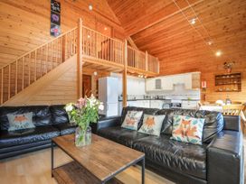 A living room with a sofa and coffee table at Heligan, St Breward