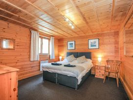 A bedroom with a bed and furniture at Heligan in St Breward