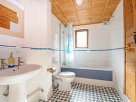 A bathroom with a basin, toilet, bathtub, and shower at Heligan in St Breward