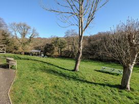 An outdoor area with a bench and picnic table at Heligan in St Breward
