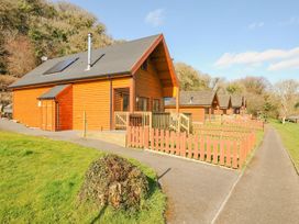 A pathway leading to log cabins at Polzeath St Breward