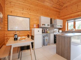 A kitchen with a table and cooking appliances at Polzeath in St Breward