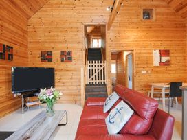 A living room with a sofa and tv at Polzeath in St Breward
