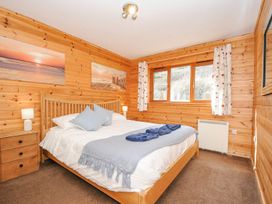 A bedroom with a bed and furniture at Polzeath in St Breward