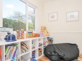 A playroom with a bookshelf and toys at Polzeath in St Breward