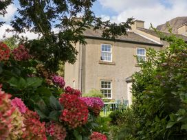 A house with garden furniture surrounded by flowers at Buckbarrow in Seascale