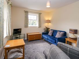 A living room with a sofa and side tables at Buckbarrow in Seascale