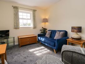 A living room with a sofa and television at Buckbarrow in Seascale