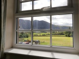 A view from a window showing mountains and a field at Buckbarrow Seascale