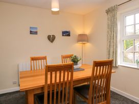 A dining room with a table and four chairs at Buckbarrow in Seascale