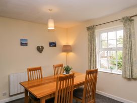 A dining room with a table and chairs at Buckbarrow Seascale