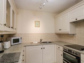 A kitchen with cabinets, sink and appliances at Buckbarrow Seascale