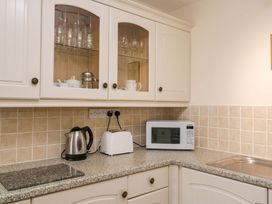 A kitchen with a microwave, kettle, and toaster at Buckbarrow in Seascale