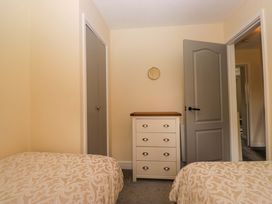 A bedroom with two beds and a dresser at Buckbarrow in Seascale