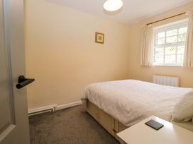 A bedroom with a bed and window at Buckbarrow in Seascale