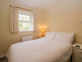 A bedroom with a bed and nightstand at Buckbarrow in Seascale