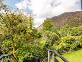 A view of a garden with trees and a mountain at Buckbarrow in Seascale