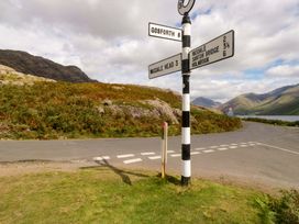 A road sign at a junction with mountains in the background at Buckbarrow Seascale