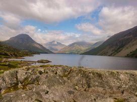 A scenic view of a lake surrounded by mountains at Buckbarrow in Seascale