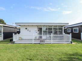 A house with a deck and fence in front at 3 Cherry Blossom in Skegness