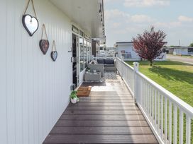 A deck with a sofa and table at 3 Cherry Blossom in Skegness