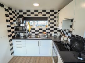 A kitchen with black and white tiles and appliances at 3 Cherry Blossom in Skegness