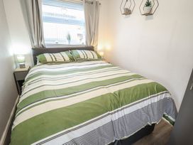 A bedroom with a bed and bedside table at 3 Cherry Blossom in Skegness