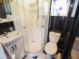 A bathroom with a shower, toilet, and sink at 3 Cherry Blossom in Skegness