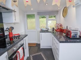 A kitchen with appliances and utensils at I C Lundy Too Bideford Bay Holiday Park near Woolfardisworthy
