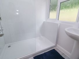 A bathroom with a shower and a sink at I C Lundy Too Bideford Bay Holiday Park near Woolfardisworthy