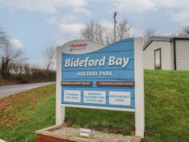 A sign for Bideford Bay Holiday Park with amenities listed near Bideford Bay Holiday Park near Woolfardisworthy
