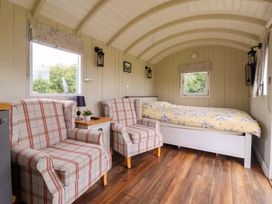 A bedroom with armchairs and bed at Shepherds hut in 