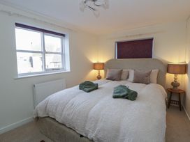 A bedroom with a bed and nightstands at Cariad Cottage in Hereford