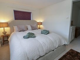 A bedroom with a bed and bedside lights at Cariad Cottage in Hereford