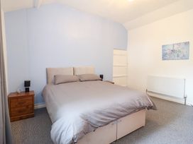 A bedroom with a bed and bedside table at Plas Yn Bonwm in Corwen