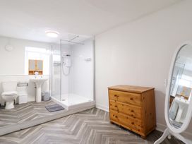 A bathroom with a shower, toilet, and sink at Plas Yn Bonwm in Corwen